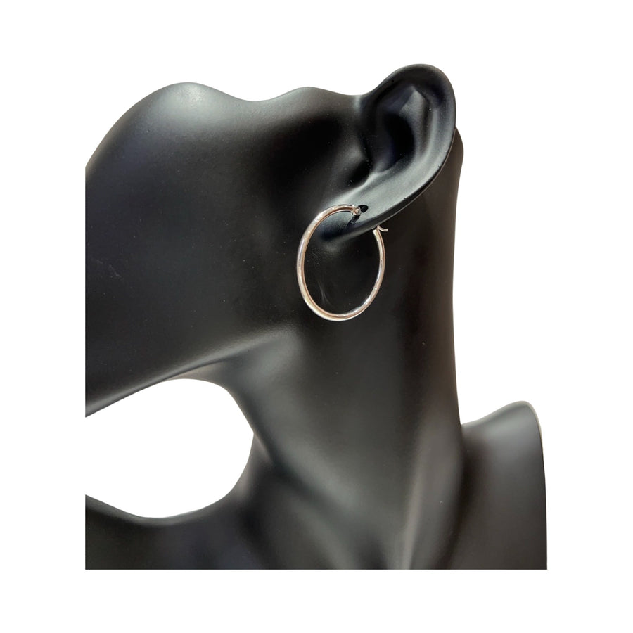 14 karat gold 2mm hoop earrings shown on a display mannequin's ear, featuring a high polished finish and latch back closure.