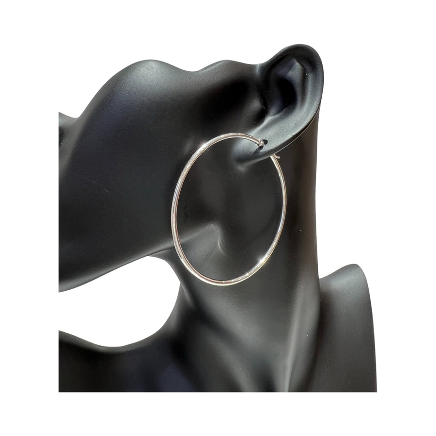 14 Karat gold 2mm hoop earrings shown on a black mannequin ear, featuring a high polished finish.