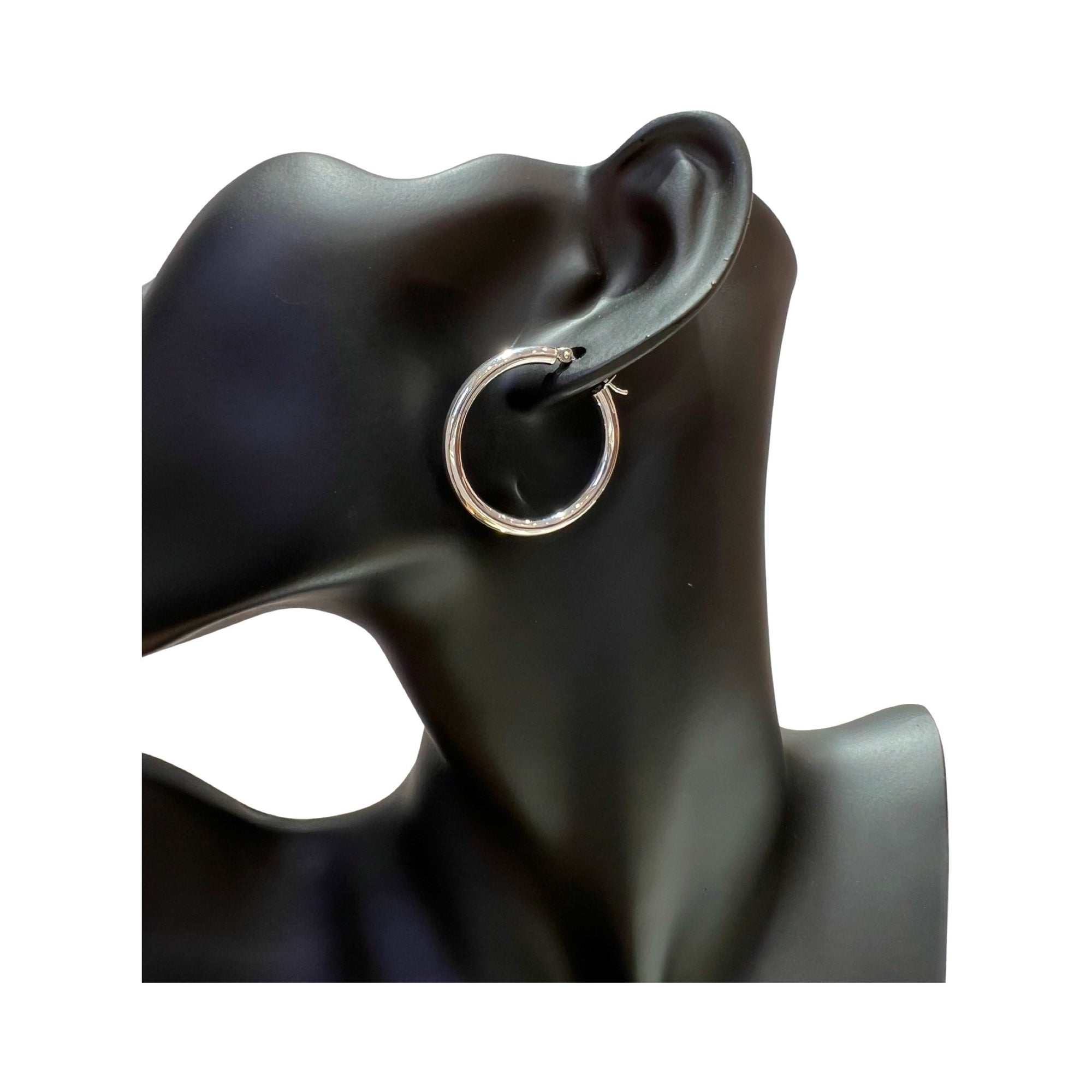 14 karat gold 3mm hoop earrings displayed on a black mannequin ear for a classic and elegant look.