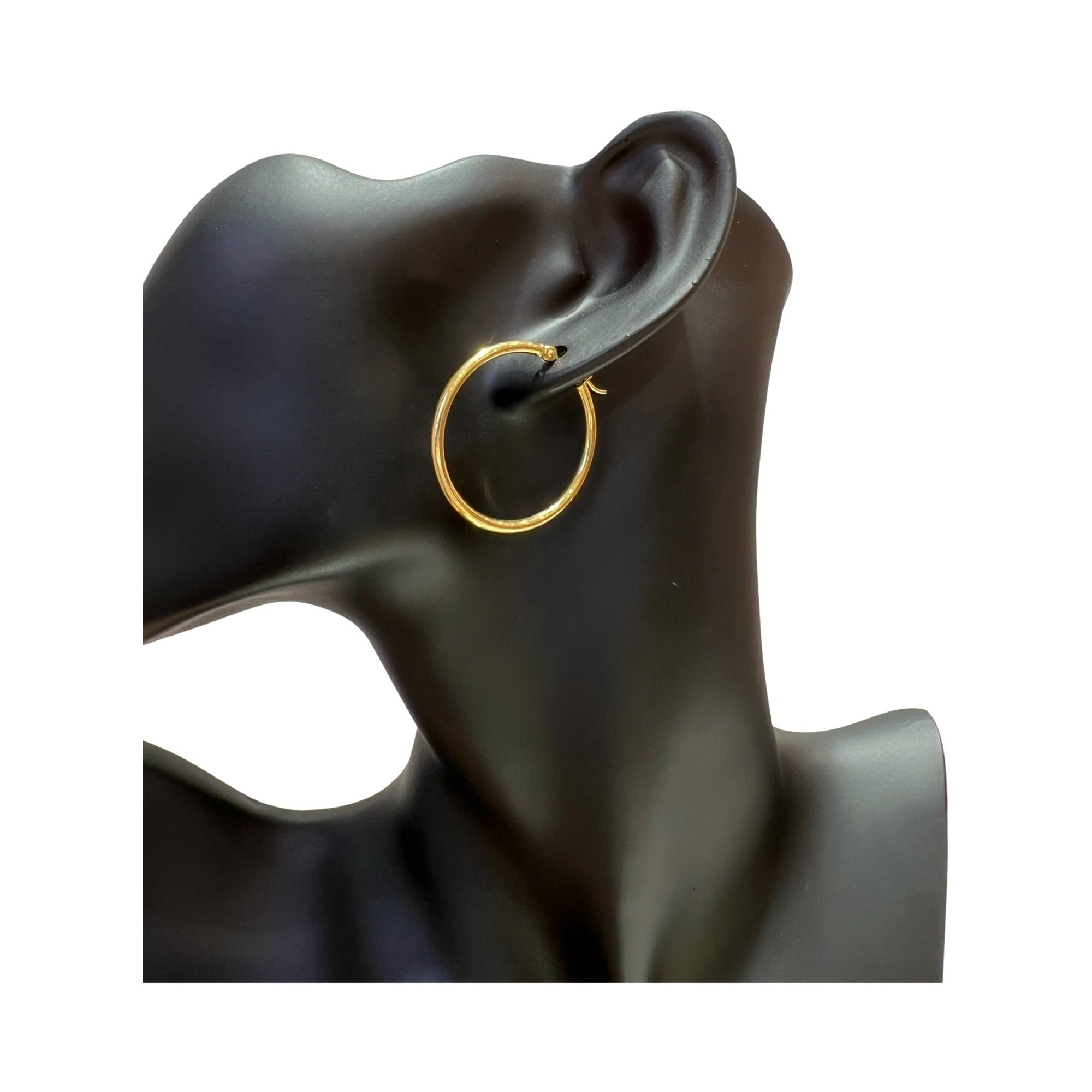 14 karat gold 2mm hoop earrings displayed on a black mannequin ear, showcasing a polished finish and classic design.