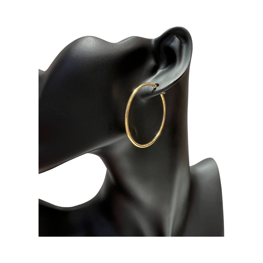 14 karat gold 2mm hoop earrings displayed on a mannequin, showcasing their polished finish and elegant style.